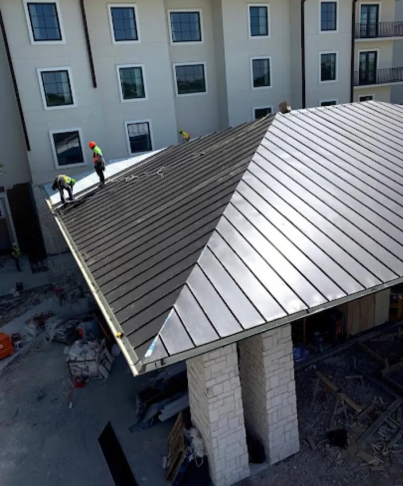 Crew installing standing seam metal roof panels on a commercial project in Birch Bay